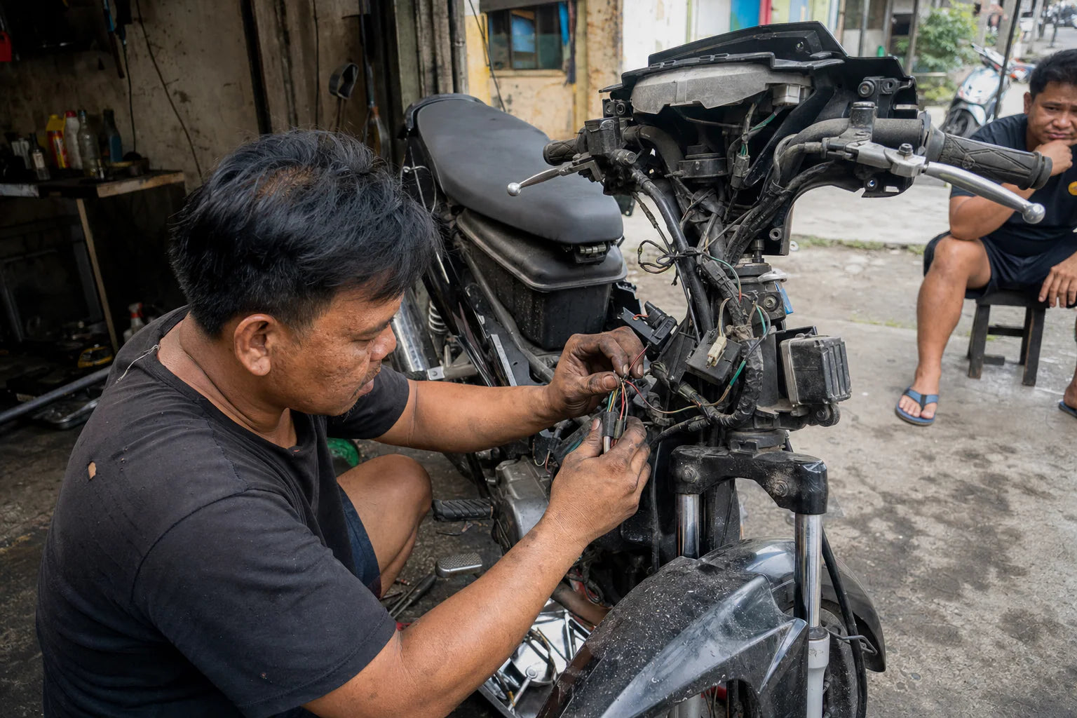 Southeast Asia motorcycle parts technician servicing a commuter bike in Cebu