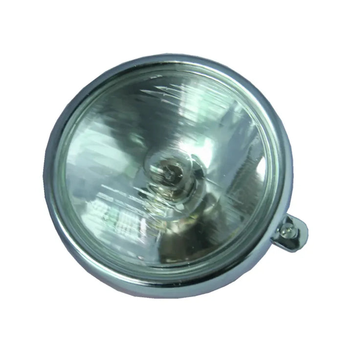 CB100 motorcycle headlamp with green-tinted lens on a white background