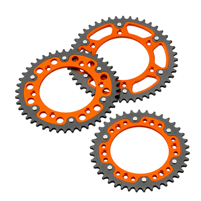 Three orange and black motorcycle sprockets