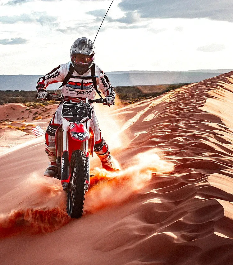 Motocross rider on a sand dune