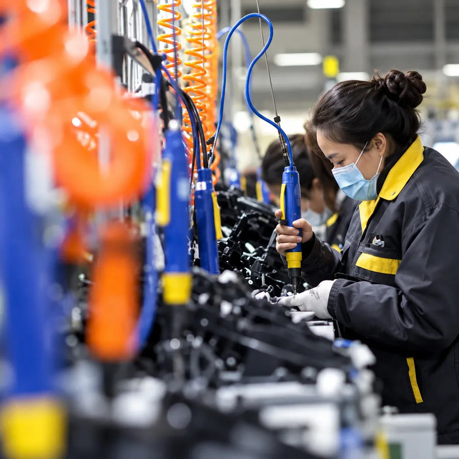 SENBEDER worker assembling motorcycle parts on the factory production line