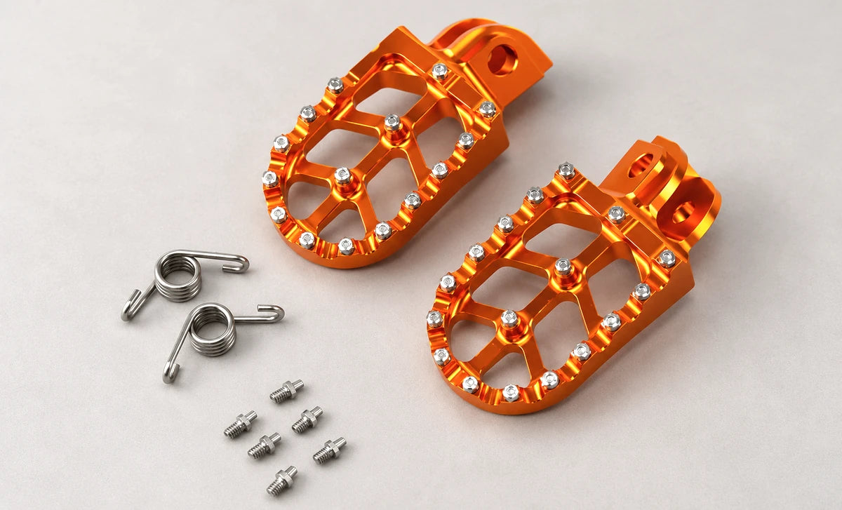 Real catalog motorcycle footpegs product photographed on a bright studio background