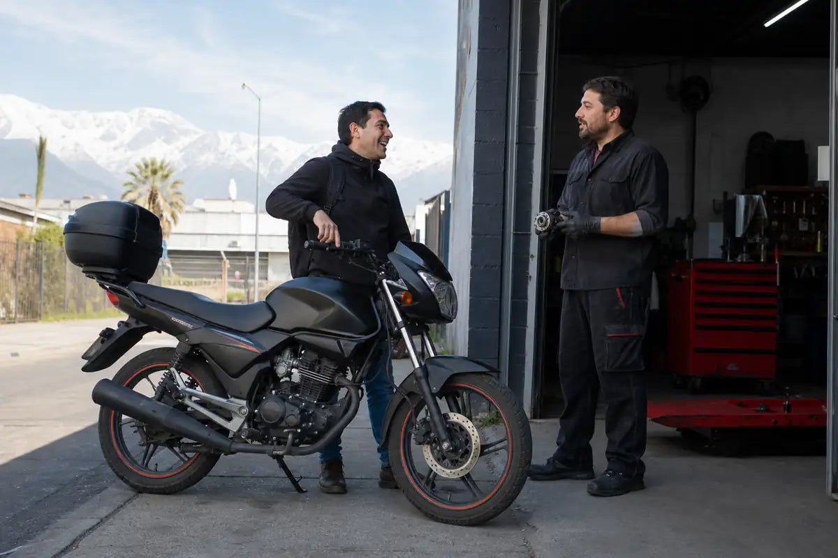 Chile commuter motorcycle at a Santiago service garage with Andes in the background