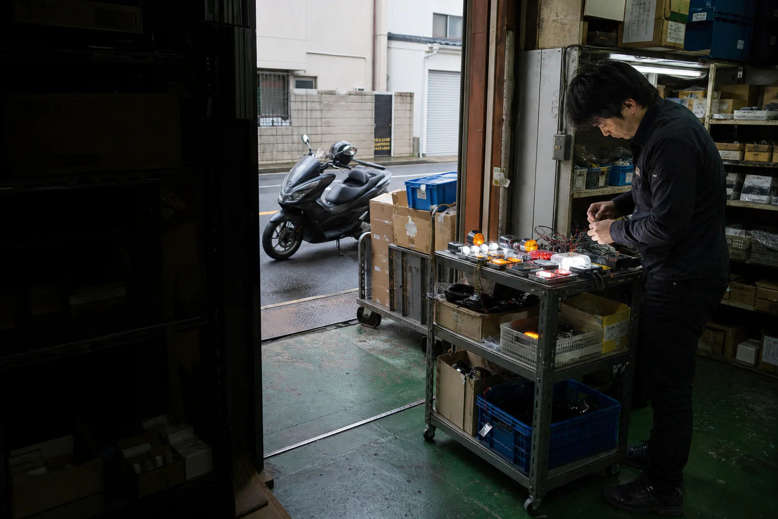Japan and Korea motorcycle parts catalog selection at a wholesale warehouse in Kyoto